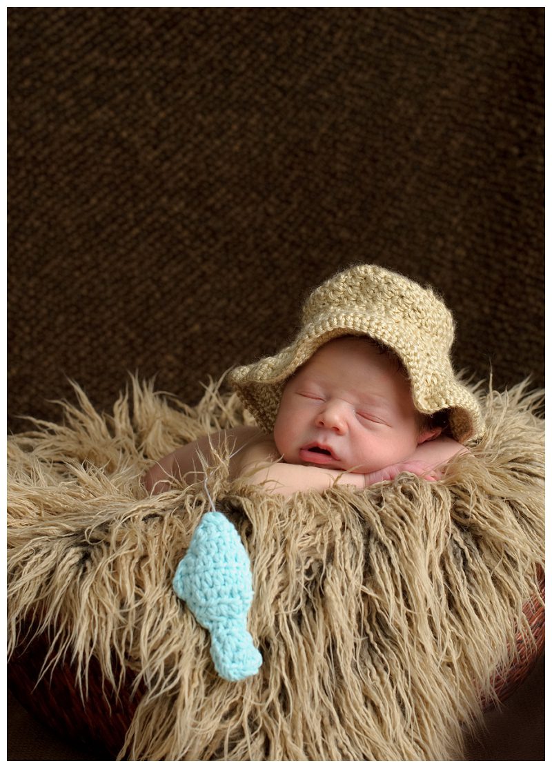 newborn with blue fish and fishing hat