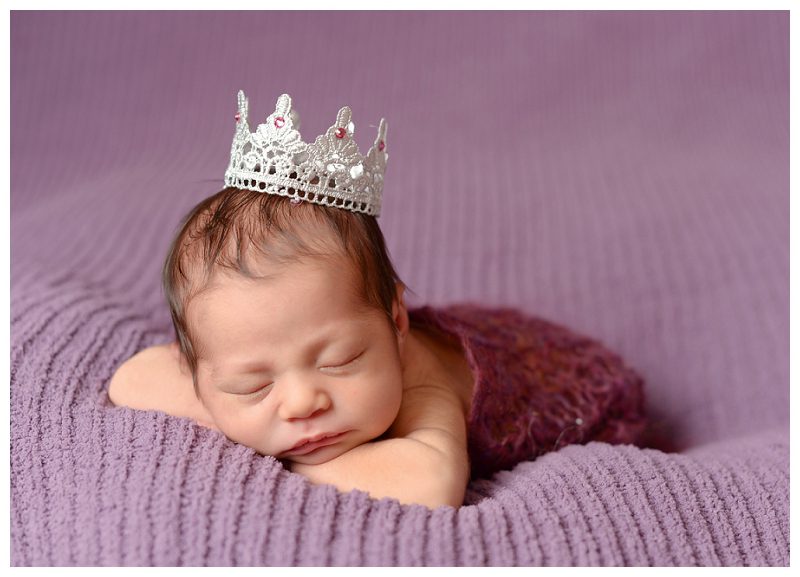newborn wearing crown