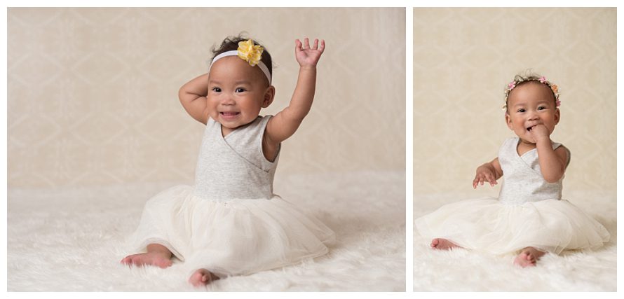 one year old in cream dress