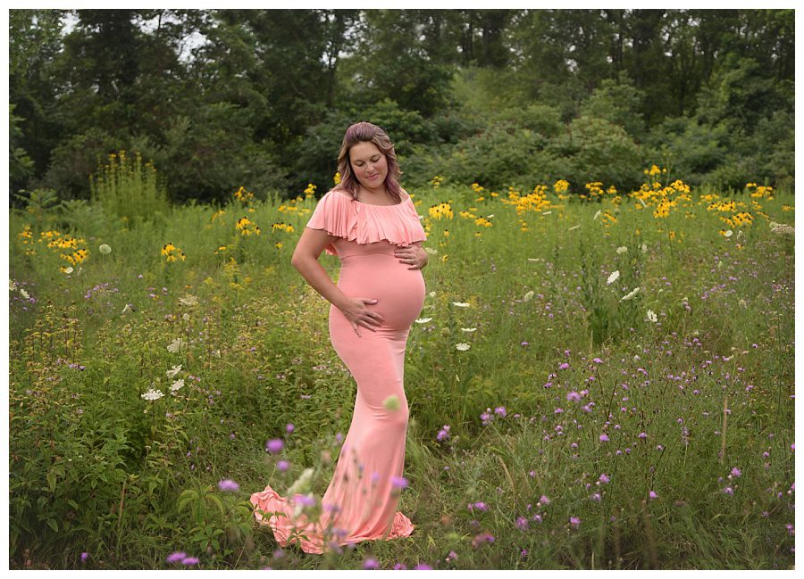 maternity pictures in a field of wildflowers