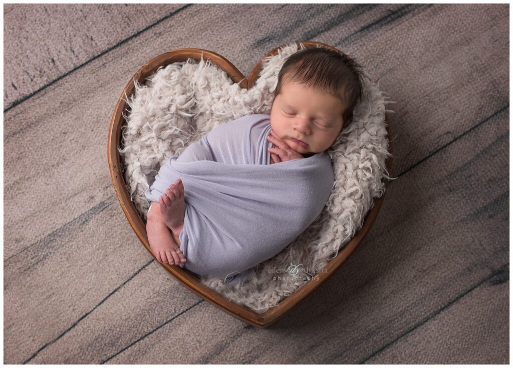 newborn in heart basket