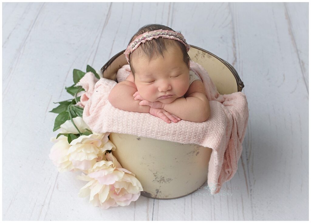 newborn in bucket prop